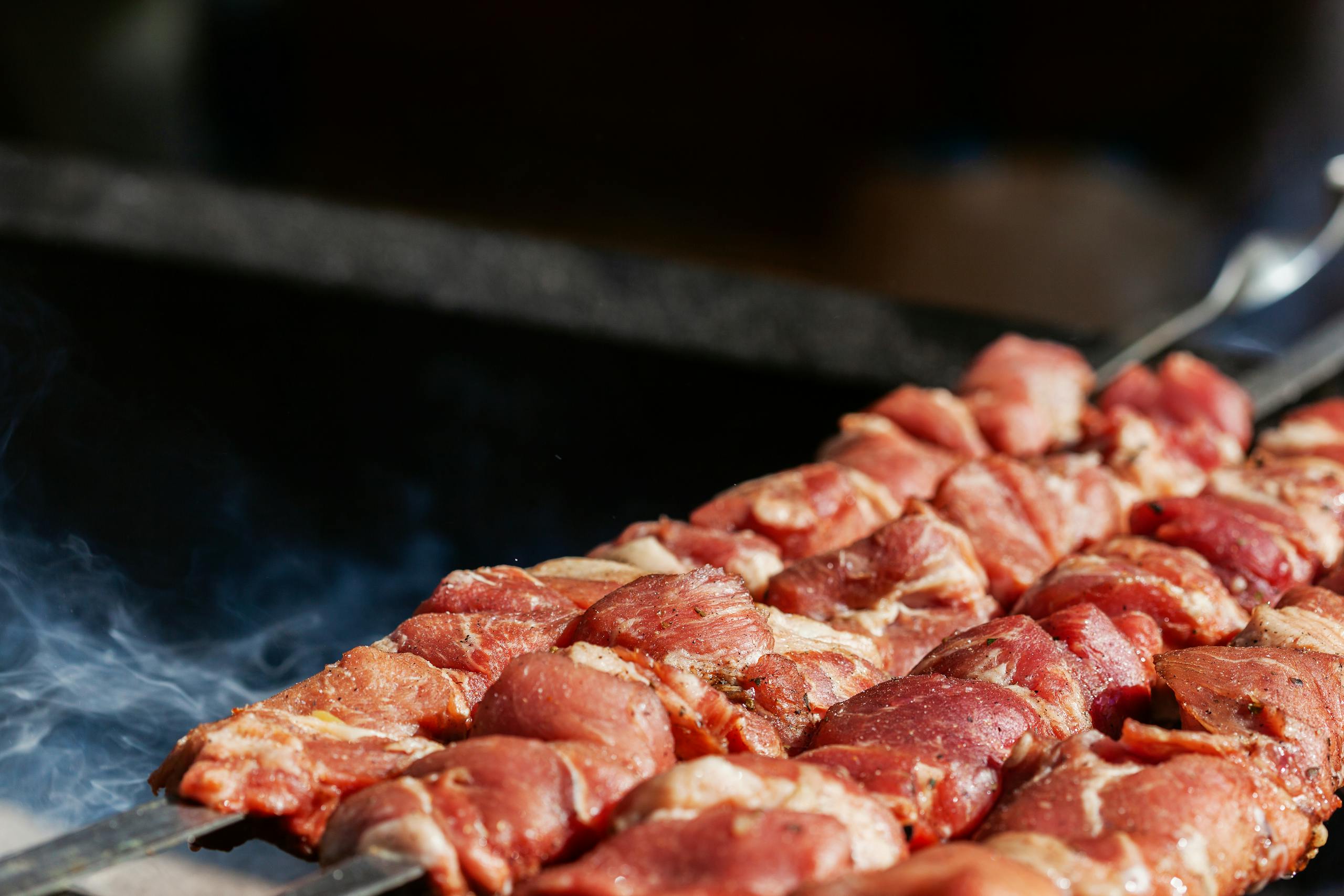 Delicious raw meat skewers ready to be grilled outdoors. Perfect for summer BBQs.